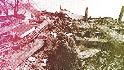 A woman sits on the rubble as emergency rescue teams search for people under the remains of destroyed buildings in Nurdagi town on the outskirts of Osmaniye, 7 February 2023