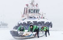 A team pushes their canoe on the ice during the Quebec Winter Carnival Ice Canoe Race in Quebec City, Canada.
