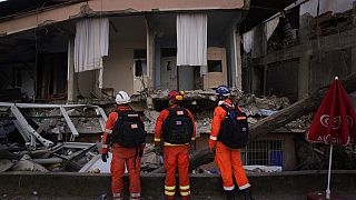 Members of the British rescue team search in a destroyed house in Antakya, southern Turkey.