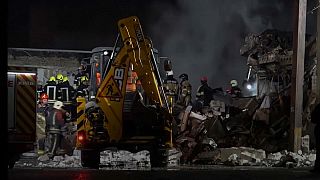 Bulldozer clearing rubble and debris after an explosion in Kyiv. 