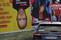 Cars drive past election campaign posters in Berlin, Germany, Feb. 6, 2023. 