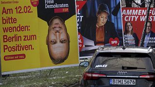 Cars drive past election campaign posters in Berlin, Germany, Feb. 6, 2023. 