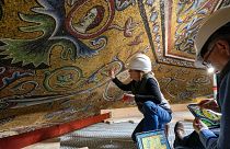 Restorers Chiara Zizola, right, and Roberto Nardi work at the restoration of the mosaics that adorn the dome of one of the oldest churches in Florence, St. John's Baptistery.