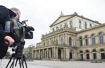 A TV cameraman films the State Opera in Hannover, Germany, 13 Feb 2023