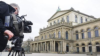 A TV cameraman films the State Opera in Hannover, Germany, 13 Feb 2023