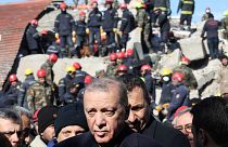 Turkish President Recep Tayyip Erdogan tours the site of destroyed buildings during his visit to the city of Kahramanmaras in southeast Turkey