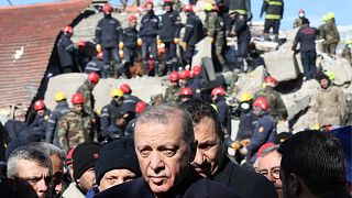 Turkish President Recep Tayyip Erdogan tours the site of destroyed buildings during his visit to the city of Kahramanmaras in southeast Turkey