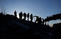 Rescue teams search for people in the rubble of destroyed buildings in Antakya, southern Turkey, Wednesday, Feb. 8, 2023.