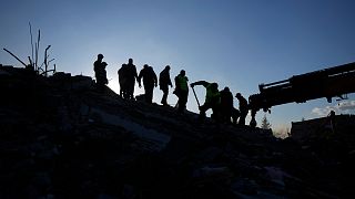 Rescue teams search for people in the rubble of destroyed buildings in Antakya, southern Turkey, Wednesday, Feb. 8, 2023.