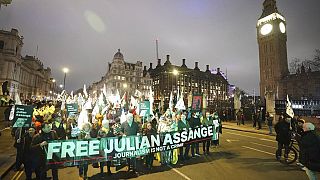 Campaigners pressing for the release of WikiLeaks founder Julian Assange take part in a demonstration during a Night Carnival in Parliament Square, London, Saturday, Feb. 11,