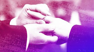 A man puts a wedding ring on his partner's finger as their civil union is being registered during a ceremony in Rome's Campidoglio, March 2015.