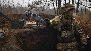 An Ukrainian soldier stands on duty with his machine gun at an undisclosed location in Donetsk region, Ukraine, Wednesday, Nov. 16, 2022.