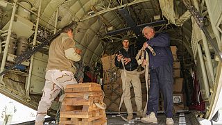 Iraqi security forces prepare humanitarian aid to be shipped on a plane to Syrian earthquake victims.