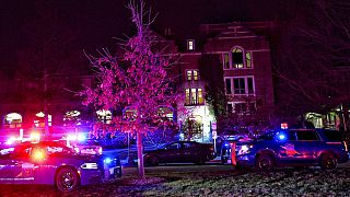 Emergency vehicles block an entrance to Michigan State University Monday night. 