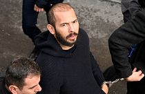  Andrew Tate arrives handcuffed and escorted by police at a courthouse in Bucharest on February 1, 2023 