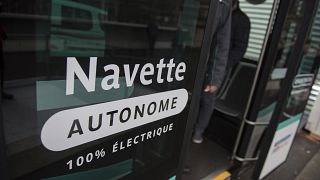 Inscription reading "Autonomous shuttle" is seen on an experimenting self-driving shuttle linking two train stations, Tuesday, Jan. 24, 2017 in Paris.