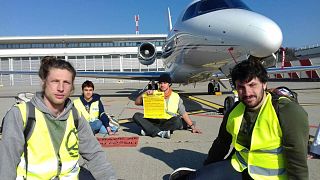 Activists and scientists got on the runway to protest private jets at Malpensa Private Airport in Italy.