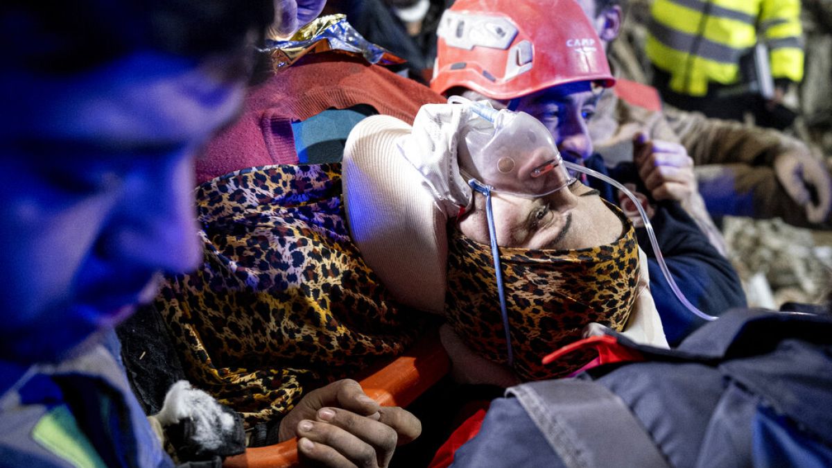 Rescue workers pull out Fatma, a Turkish woman, from the debris of a collapsed building in Antakya, southern Turkey, Tuesday, Feb. 14, 2023. 