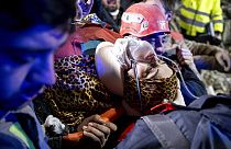 Rescue workers pull out Fatma, a Turkish woman, from the debris of a collapsed building in Antakya, southern Turkey, Tuesday, Feb. 14, 2023.