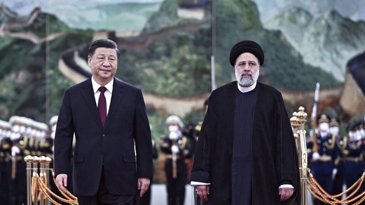 Visiting Iranian President Ebrahim Raisi, right, walks with Chinese President Xi Jinping. Tuesday 14 February 2023.
