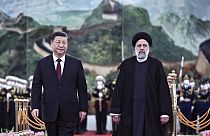 Visiting Iranian President Ebrahim Raisi, right, walks with Chinese President Xi Jinping. Tuesday 14 February 2023.