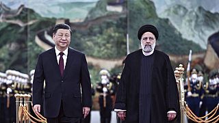 Visiting Iranian President Ebrahim Raisi, right, walks with Chinese President Xi Jinping. Tuesday 14 February 2023.