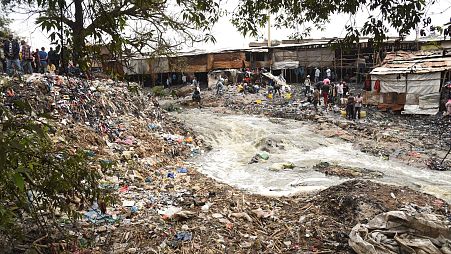 The Nairobi River runs through waste clothing at Gikomba market.