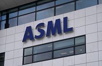 The logo of ASML, a leading maker of semiconductor production equipment, hangs on the head office in Veldhoven, Netherlands