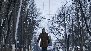 A local resident walks along a street in Bakhmut, Donetsk region, Ukraine, Tuesday, Feb. 14, 2023