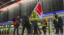 Airport employees in strike vests are on the move in Departure Hall B in Terminal 1 of Frankfurt Airport in Munich, Germany, 17 February 2023