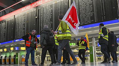 Airport employees in strike vests are on the move in Departure Hall B in Terminal 1 of Frankfurt Airport in Munich, Germany, 17 February 2023