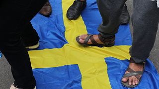 FILE: Activists step on the Swedish flag as demonstrators gather outside the Swedish Embassy in Jakarta on January 30, 2023,