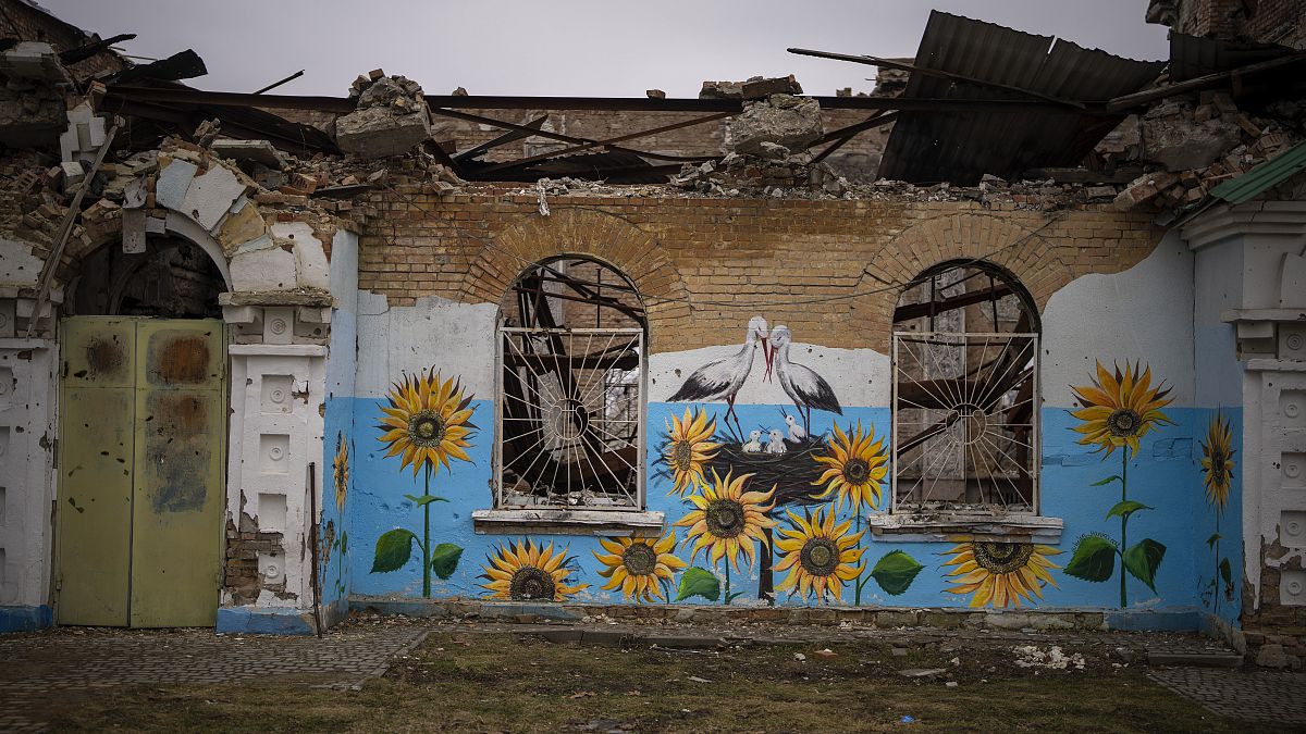 A painting decorates the façade of a house damaged during the Russian occupation in Bucha, near Kyiv,