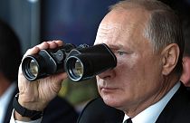 FILE: Russian President Vladimir Putin holds binoculars while watching military exercises Center-2019 at Donguz shooting range near Orenburg, Russia, Sept. 20, 2019. 