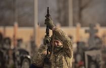 A Ukrainian serviceman fires his weapon in the air in Kharkiv, Ukraine, Thursday, Feb. 16, 2023.