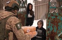 A member of Ukraine's White Angels unit delivers bread to a family in Krasnohorivka, a city on the front line. 18 Feb, 2023