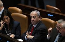 Israel's Prime Minister Benjamin Netanyahu, centre, in Israel's parliament, the Knesset, for a vote on a contentious plan to overhaul the country's judicial system.
