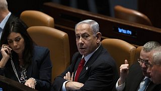 Israel's Prime Minister Benjamin Netanyahu, centre, in Israel's parliament, the Knesset, for a vote on a contentious plan to overhaul the country's judicial system.