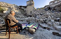 Turkish citizen Mehmet Ismet prays in front of the historic Habib Najjar mosque which was destroyed during the devastating earthquake,  Saturday, Feb. 11, 2023.
