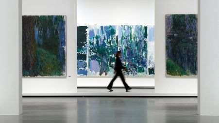 French painter Claude Monet's (L and R) and an American artist Joan Mitchell's paintings (C) exposed at "Monet - Mitchell" exhibition