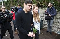 Mourners arrive with a rose at the entrance of a private school in France after a teacher was stabbed to death by a high school student on Wednesday morning.