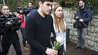 Mourners arrive with a rose at the entrance of a private school in France after a teacher was stabbed to death by a high school student on Wednesday morning.