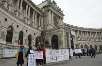 Protesters denounced Russia and Vladimir Putin outside the meeting