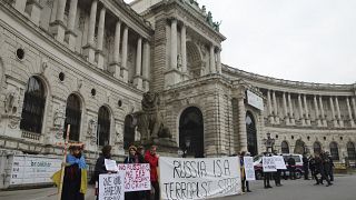 Demonstrators protest in front of Hofburg Palace during an OSCE Parliamentary Assembly, in Vienna, Austria, Thursday, Feb. 23, 2023.