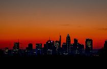 The sun is about to rise behind the buildings of the banking district in Frankfurt, Germany, Wednesday, March 9, 2022