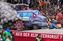 A carnival float depicts protesting climate activists of the 'Last Generation' during the traditional carnival parade in Duesseldorf, Germany, 20 February 2023.