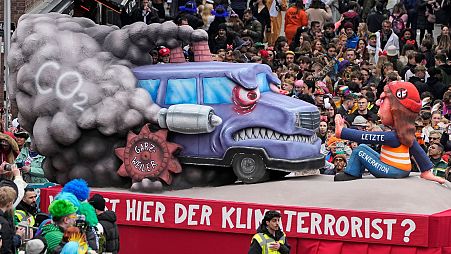 A carnival float depicts protesting climate activists of the 'Last Generation' during the traditional carnival parade in Duesseldorf, Germany, 20 February 2023.