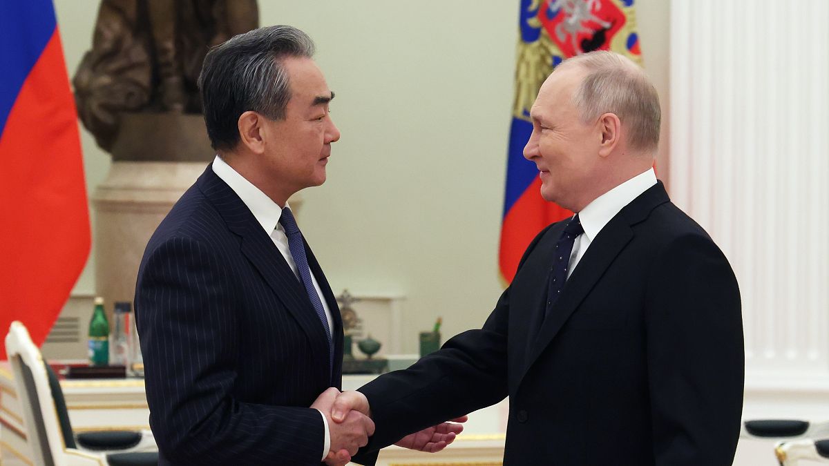 Russian President Vladimir Putin shakes hands with Chinese Communist Party's foreign policy chief Wang Yi during their meeting at the Kremlin in Moscow, Russia, Feb. 22, 2023.