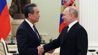 Russian President Vladimir Putin shakes hands with Chinese Communist Party's foreign policy chief Wang Yi during their meeting at the Kremlin in Moscow, Russia, Feb. 22, 2023.