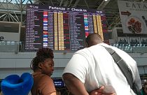 Passengers look at check-in times for flights during a nationwide strike of airports ground staff, and check-in services at Rome's Fiumicino Airport.